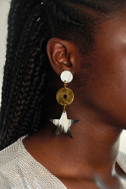 model wearing mic drop star dangle earrings made from horn and brass