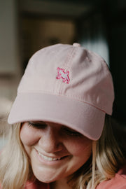 Zena pink baseball hat photographed on a super cute smiling model